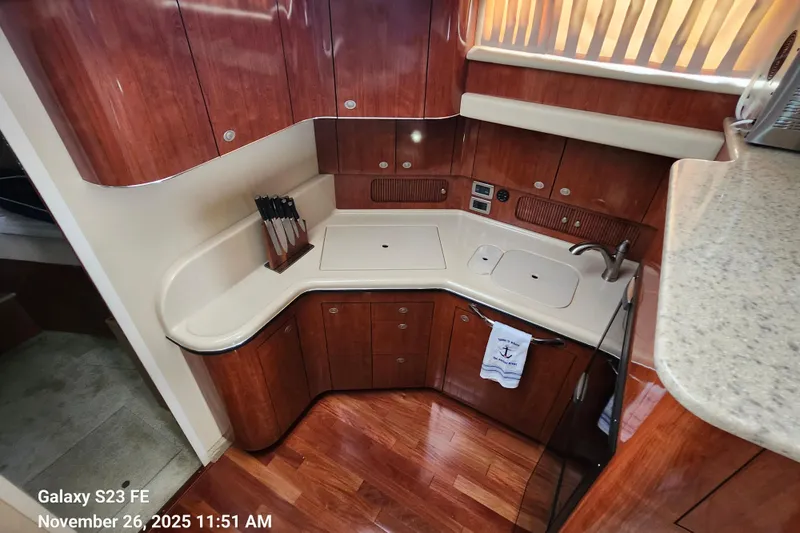 Magnolia Belle Yacht Photos Pics Luxurious 2004 Sea Ray 390 Motor Yacht kitchen with wood cabinetry and modern amenities.