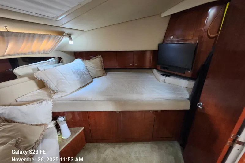 Magnolia Belle Yacht Photos Pics Cozy bedroom in 2004 Sea Ray 390 Motor Yacht with TV and plush bedding.