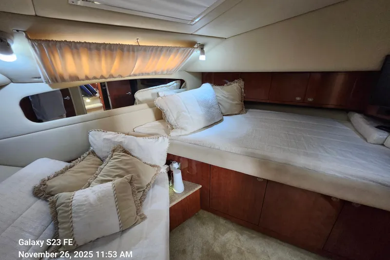 Magnolia Belle Yacht Photos Pics Luxurious 2004 Sea Ray 390 Motor Yacht cabin with plush bedding and elegant wood finishes.