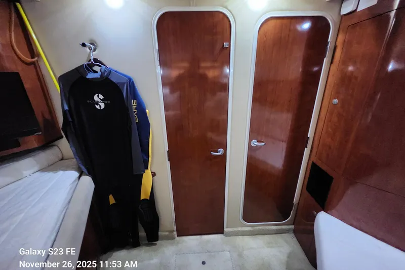 Magnolia Belle Yacht Photos Pics Interior of 2004 Sea Ray 390 Motor Yacht with wetsuit and wooden doors.