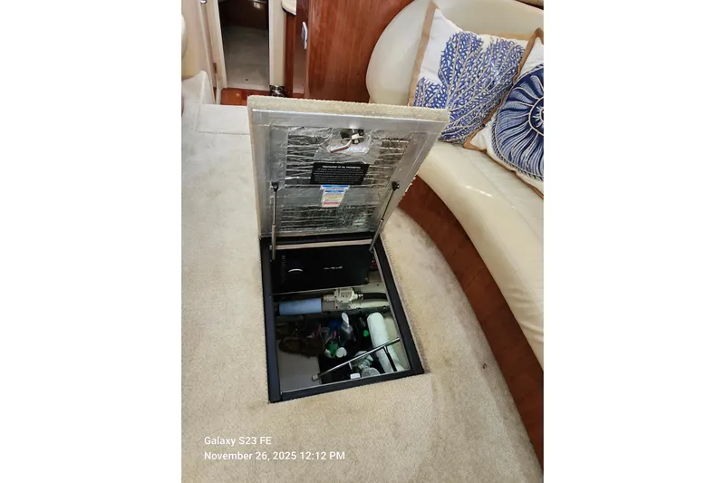 Magnolia Belle Yacht Photos Pics Open hatch in 2004 Sea Ray 390 Motor Yacht interior, revealing storage compartment.