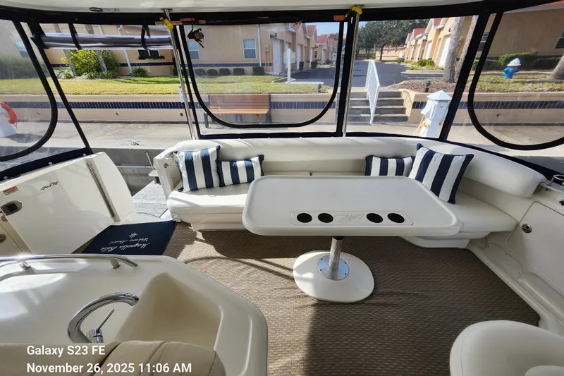 Magnolia Belle Yacht Photos Pics 2004 Sea Ray 390 Motor Yacht interior with seating, table, and striped cushions.