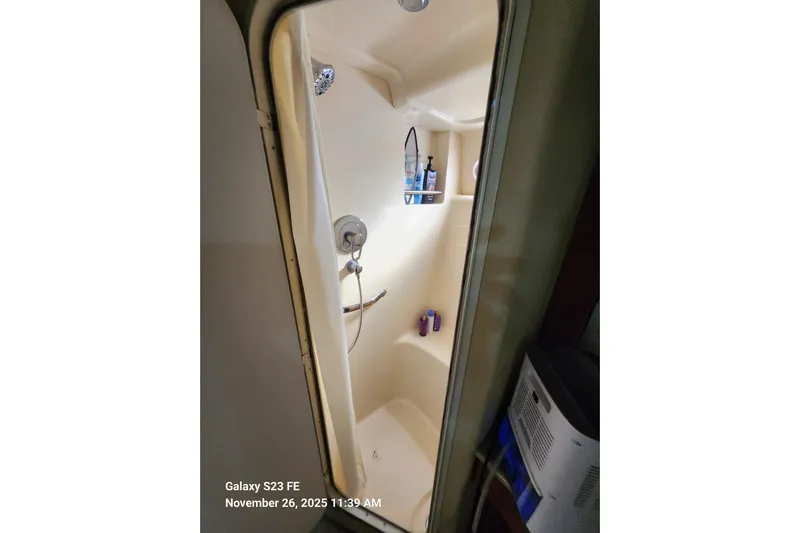 Magnolia Belle Yacht Photos Pics Shower area inside 2004 Sea Ray 390 Motor Yacht, featuring toiletries and a curtain.