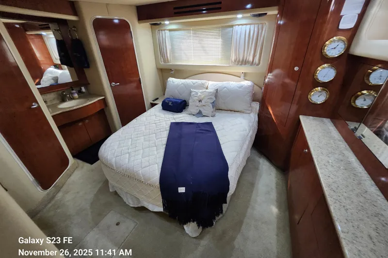 Magnolia Belle Yacht Photos Pics Luxurious 2004 Sea Ray 390 Motor Yacht bedroom with elegant wood finishes and cozy bedding.