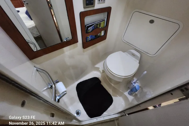 Magnolia Belle Yacht Photos Pics Bathroom interior of 2004 Sea Ray 390 Motor Yacht with toilet and mirror.