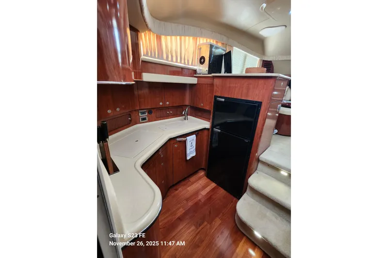 Magnolia Belle Yacht Photos Pics Interior of 2004 Sea Ray 390 Motor Yacht with modern kitchen and wood finish.