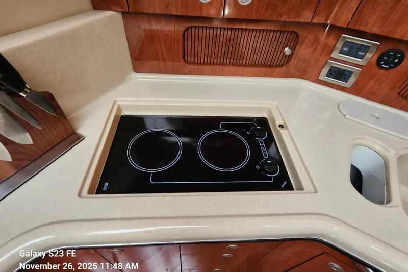 Magnolia Belle Yacht Photos Pics 2004 Sea Ray 390 Motor Yacht kitchen with electric stove and wooden cabinetry.