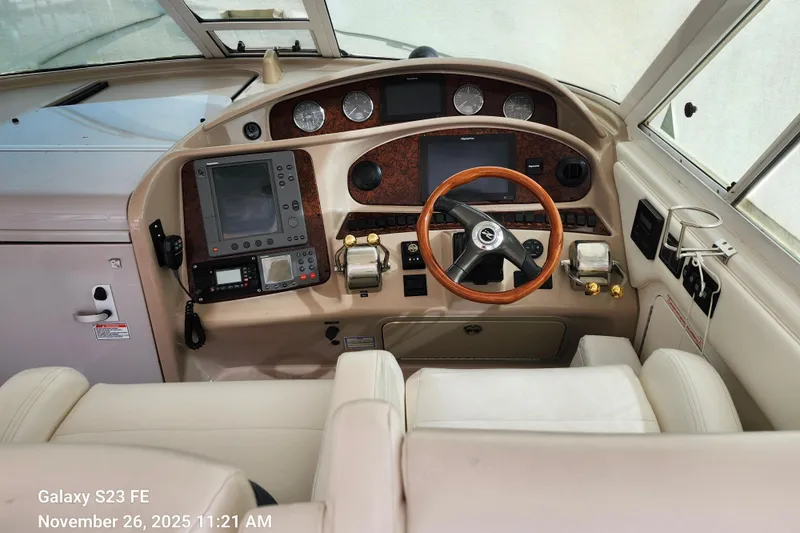 Magnolia Belle Yacht Photos Pics 2004 Sea Ray 390 Motor Yacht, Magnolia Belle, helm with navigation equipment and wooden steering wheel.