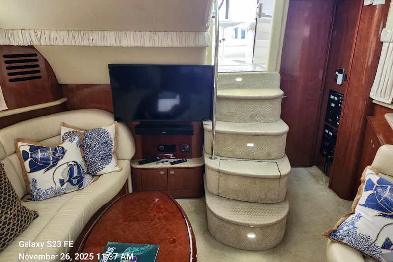 Magnolia Belle Yacht Photos Pics 2004 Sea Ray 390 Motor Yacht interior with TV, stairs, and plush seating.