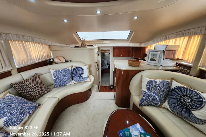 Magnolia Belle Yacht Photos Pics Luxurious interior of a 2004 Sea Ray 390 Motor Yacht with elegant seating and decor.