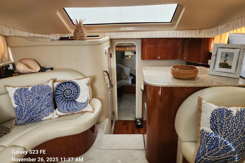 Magnolia Belle Yacht Photos Pics Interior of 2004 Sea Ray 390 Motor Yacht with elegant decor and nautical-themed cushions.