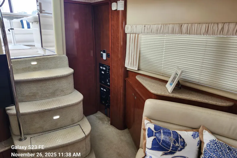 Magnolia Belle Yacht Photos Pics Interior of 2004 Sea Ray 390 Motor Yacht with carpeted stairs and cozy seating area.