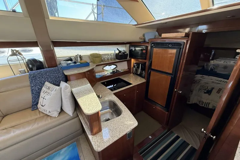 Done Building Yacht Photos Pics Interior of 2008 Meridian 459 Motoryacht with kitchen and cozy seating area.