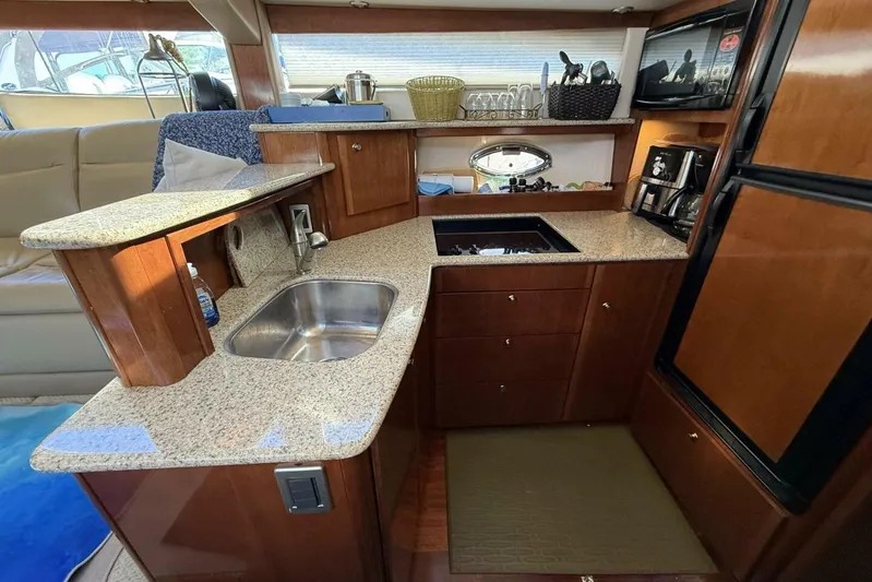 Done Building Yacht Photos Pics Luxurious kitchen interior of 2008 Meridian 459 Motoryacht with granite countertops and modern appliances.