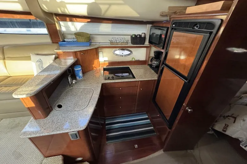 Done Building Yacht Photos Pics Luxurious 2008 Meridian 459 Motoryacht kitchen with granite countertops and modern appliances.