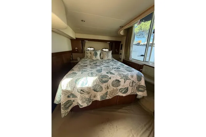 Done Building Yacht Photos Pics Luxurious bedroom interior of 2008 Meridian 459 Motoryacht with nautical-themed bedding.