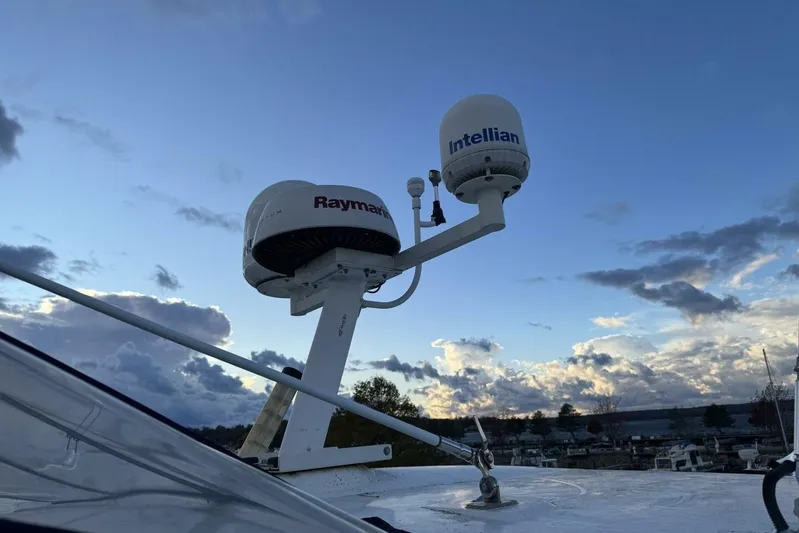 Done Building Yacht Photos Pics Radar and satellite equipment on 2008 Meridian 459 Motoryacht against a cloudy sky.