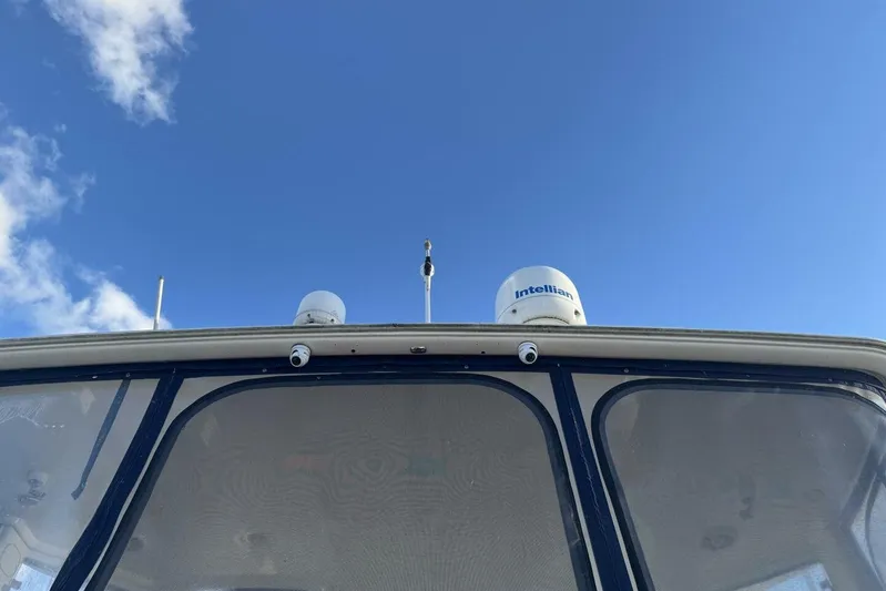 Done Building Yacht Photos Pics 2008 Meridian 459 Motoryacht with Intellian satellite dome against blue sky.