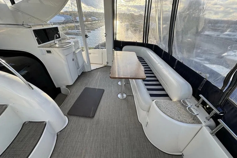 Done Building Yacht Photos Pics 2008 Meridian 459 Motoryacht interior with seating, table, and kitchenette, overlooking marina.