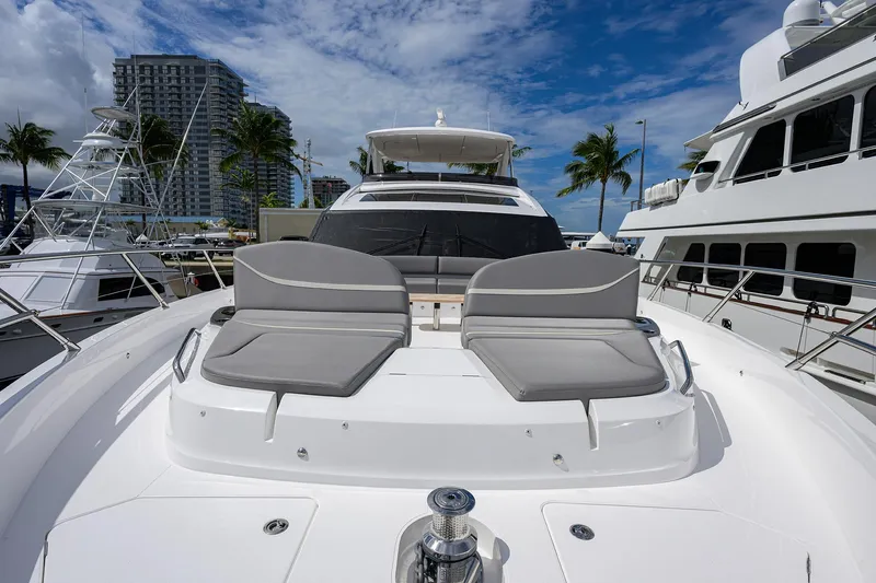  Yacht Photos Pics Luxury 2026 Princess S72 yacht with sun loungers, docked near palm trees and buildings.