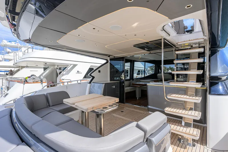  Yacht Photos Pics Luxurious 2026 Princess S72 yacht interior with modern seating and elegant staircase.