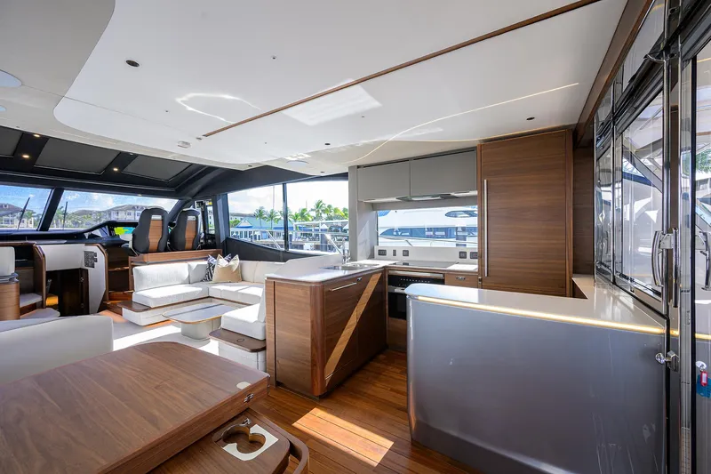  Yacht Photos Pics Luxurious interior of 2026 Princess S72 yacht with modern kitchen and seating area.