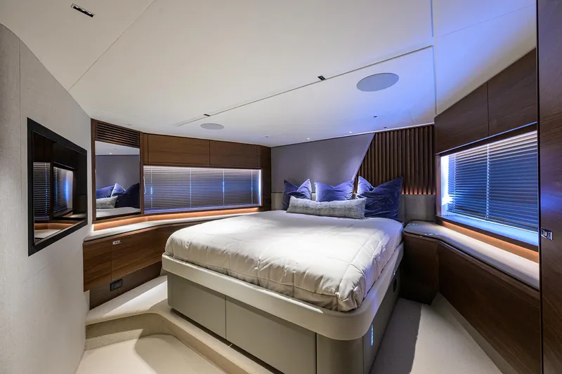  Yacht Photos Pics Luxurious bedroom interior of 2026 Princess S72 yacht with modern design and ambient lighting.