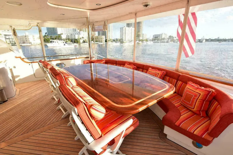 Waterford (name Reserved) Yacht Photos Pics Luxurious yacht deck with red cushioned seating and wooden table, Westport Modified Hull Sovereign, 2001.