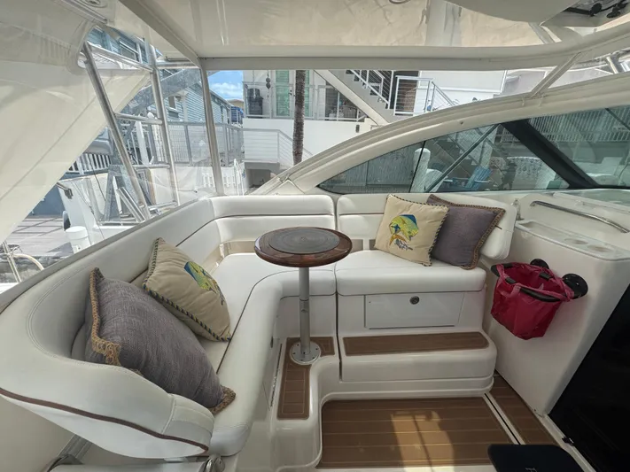  Yacht Photos Pics Luxurious seating area on a 2006 Tiara Yachts 4200 Open, featuring plush cushions and a wooden table.