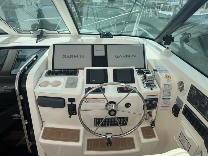  Yacht Photos Pics Cockpit of 2006 Tiara Yachts 4200 Open with Garmin navigation system and steering wheel.