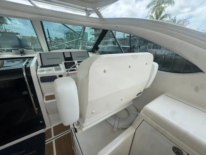  Yacht Photos Pics 2006 Tiara Yachts 4200 Open helm with Garmin navigation, white seating, and tropical backdrop.
