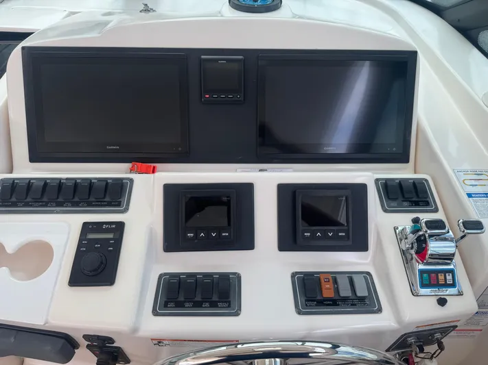  Yacht Photos Pics Helm dashboard of 2006 Tiara Yachts 4200 Open with navigation screens and controls.