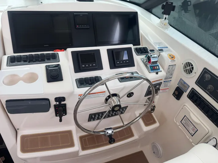  Yacht Photos Pics Helm of 2006 Tiara Yachts 4200 Open with steering wheel and navigation controls.