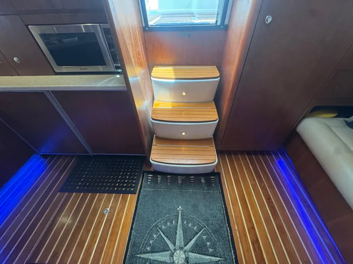  Yacht Photos Pics Interior of 2006 Tiara Yachts 4200 Open with wooden steps and modern kitchen area.