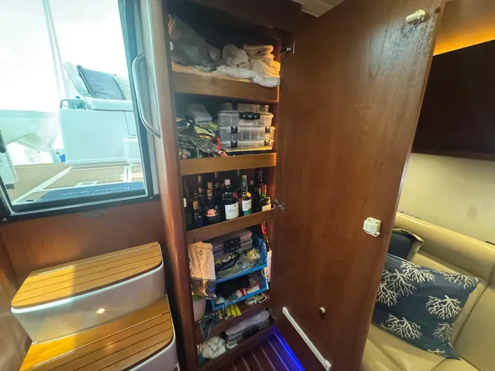  Yacht Photos Pics 2006 Tiara Yachts 4200 Open interior with wooden storage shelves and nautical-themed decor.