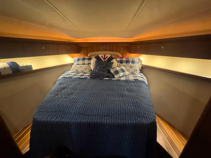  Yacht Photos Pics Cozy cabin interior of 2006 Tiara Yachts 4200 Open with nautical-themed bedding.