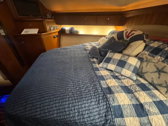  Yacht Photos Pics Cozy cabin interior of 2006 Tiara Yachts 4200 Open with nautical-themed bedding.