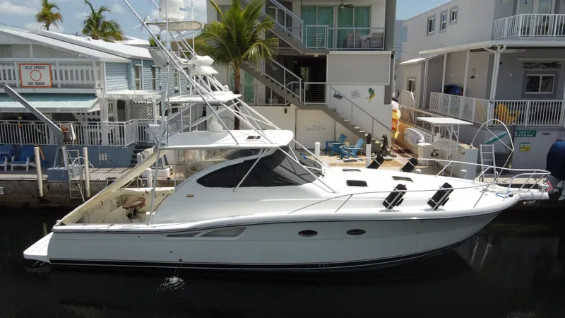  Yacht Photos Pics 2006 Tiara Yachts 4200 Open docked near waterfront homes, featuring sleek design and fishing equipment.