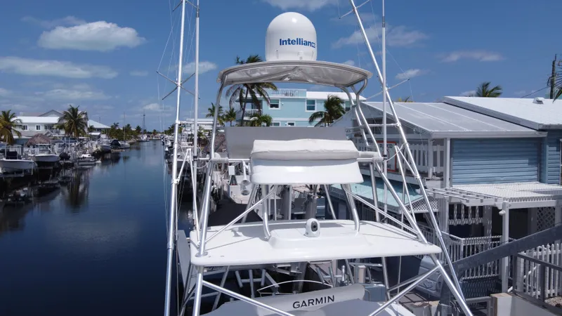  Yacht Photos Pics 2006 Tiara Yachts 4200 Open docked in a scenic canal with clear skies.