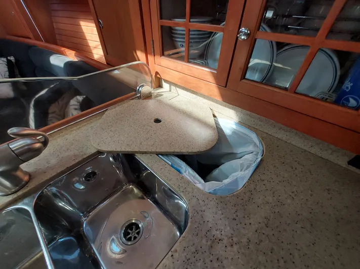 "heron" Yacht Photos Pics 2009 Hunter 49 yacht kitchen with sink, countertop, and wooden cabinets.