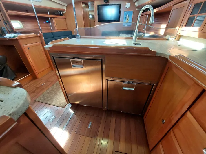 "heron" Yacht Photos Pics Interior of 2009 Hunter 49 yacht with wooden cabinetry and modern kitchen amenities.