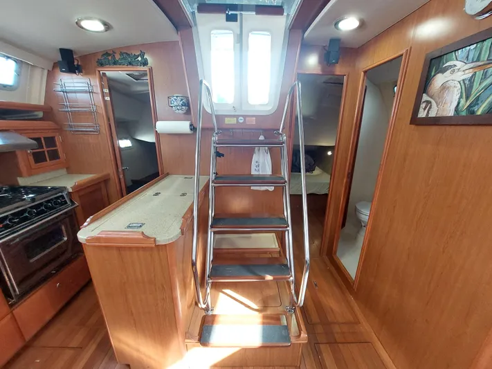 "heron" Yacht Photos Pics Interior of 2009 Hunter 49 yacht with wooden cabinetry and stainless steel stairs.