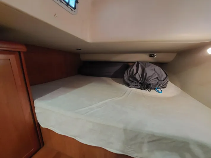 "heron" Yacht Photos Pics Cozy cabin interior of 2009 Hunter 49 sailboat with bed and storage.