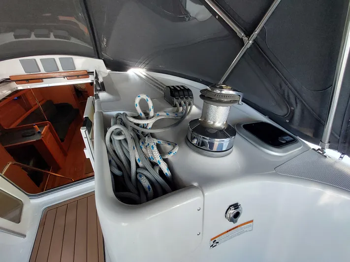 "heron" Yacht Photos Pics 2009 Hunter 49 sailboat cockpit with winch and ropes under canopy.