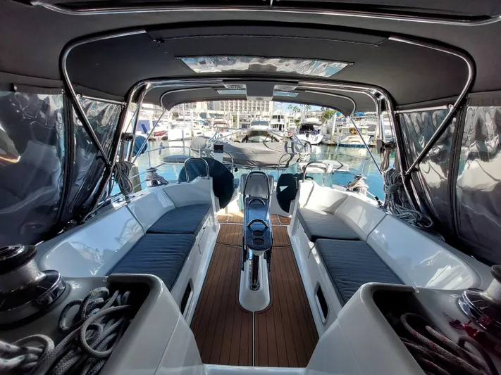"heron" Yacht Photos Pics Interior view of a 2009 Hunter 49 sailboat cockpit with marina background.