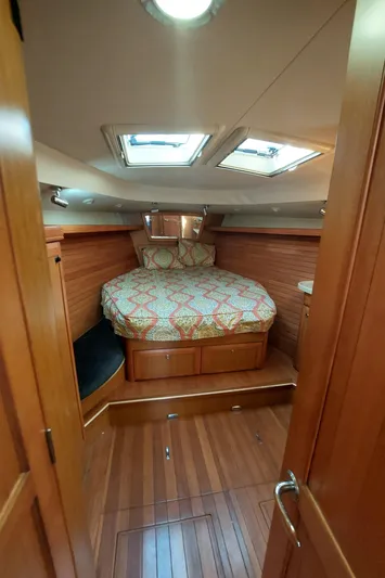 "heron" Yacht Photos Pics Cozy cabin interior of 2009 Hunter 49 sailboat with wood finish and skylights.