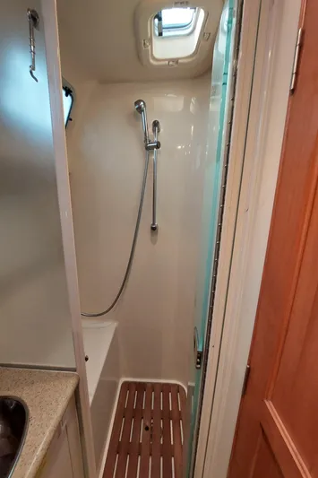 "heron" Yacht Photos Pics Compact shower area in 2009 Hunter 49 yacht with wooden floor mat.