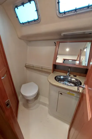 "heron" Yacht Photos Pics 2009 Hunter 49 yacht bathroom with sink, toilet, and mirror.