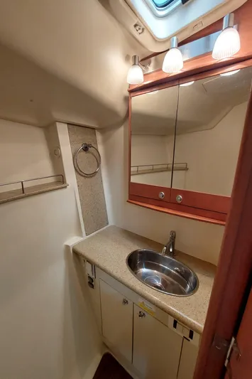"heron" Yacht Photos Pics Compact bathroom in 2009 Hunter 49 yacht with sink, mirror, and lighting.