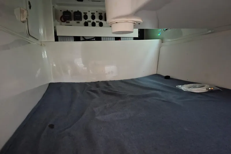 Paradise Bound Yacht Photos Pics 2008 Everglades 350LX cabin interior with control panel and blue bedding.